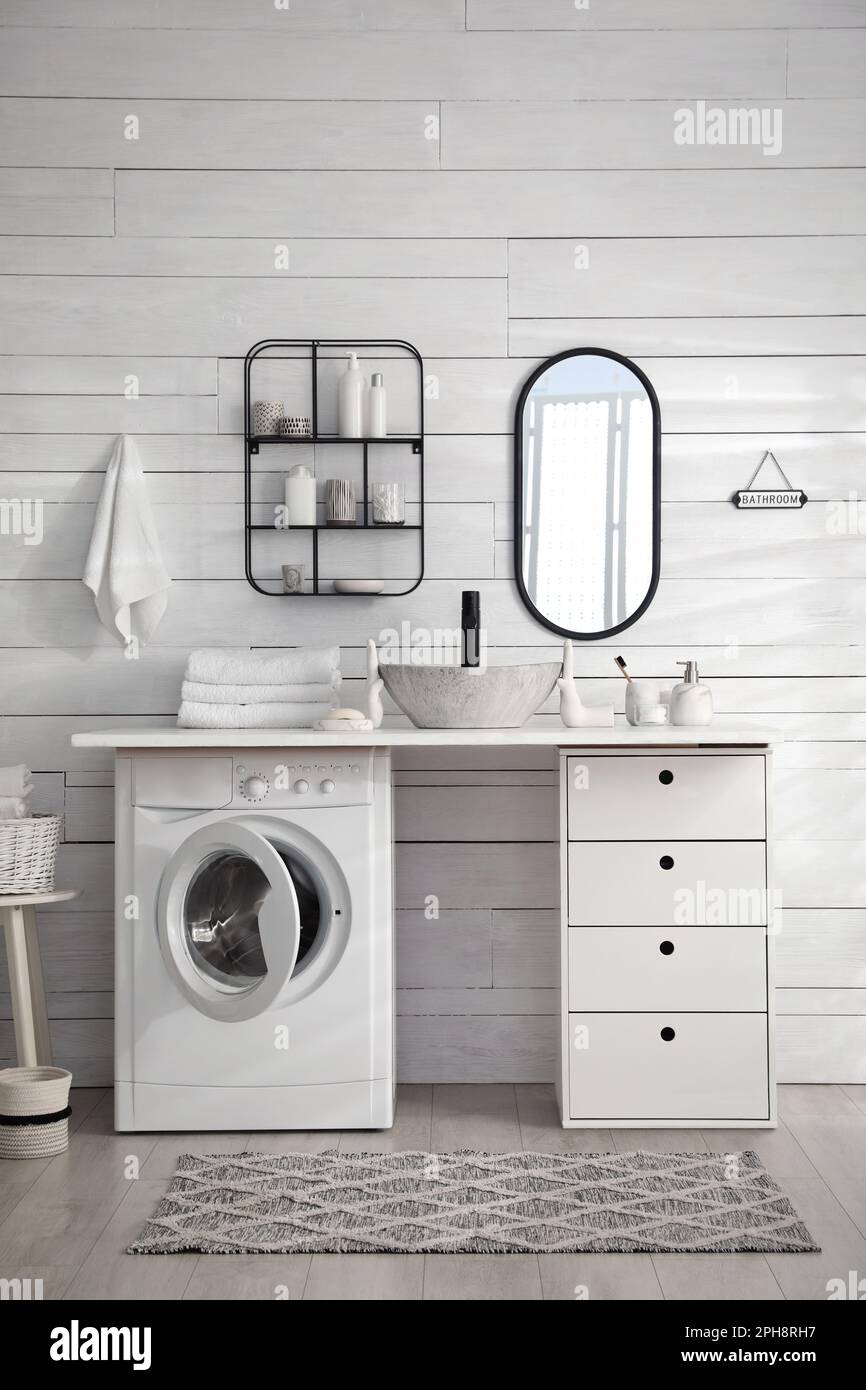 Stylish bathroom interior with modern washing machine Stock Photo