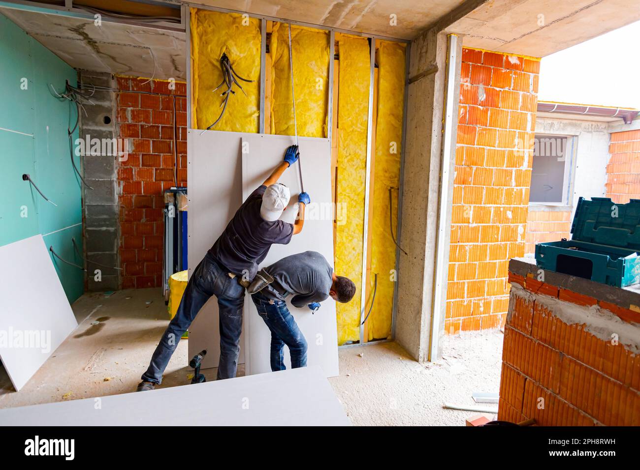 Checking Point Wall Teamwork, repairmen are measuring with a tape measure, checking wall ...