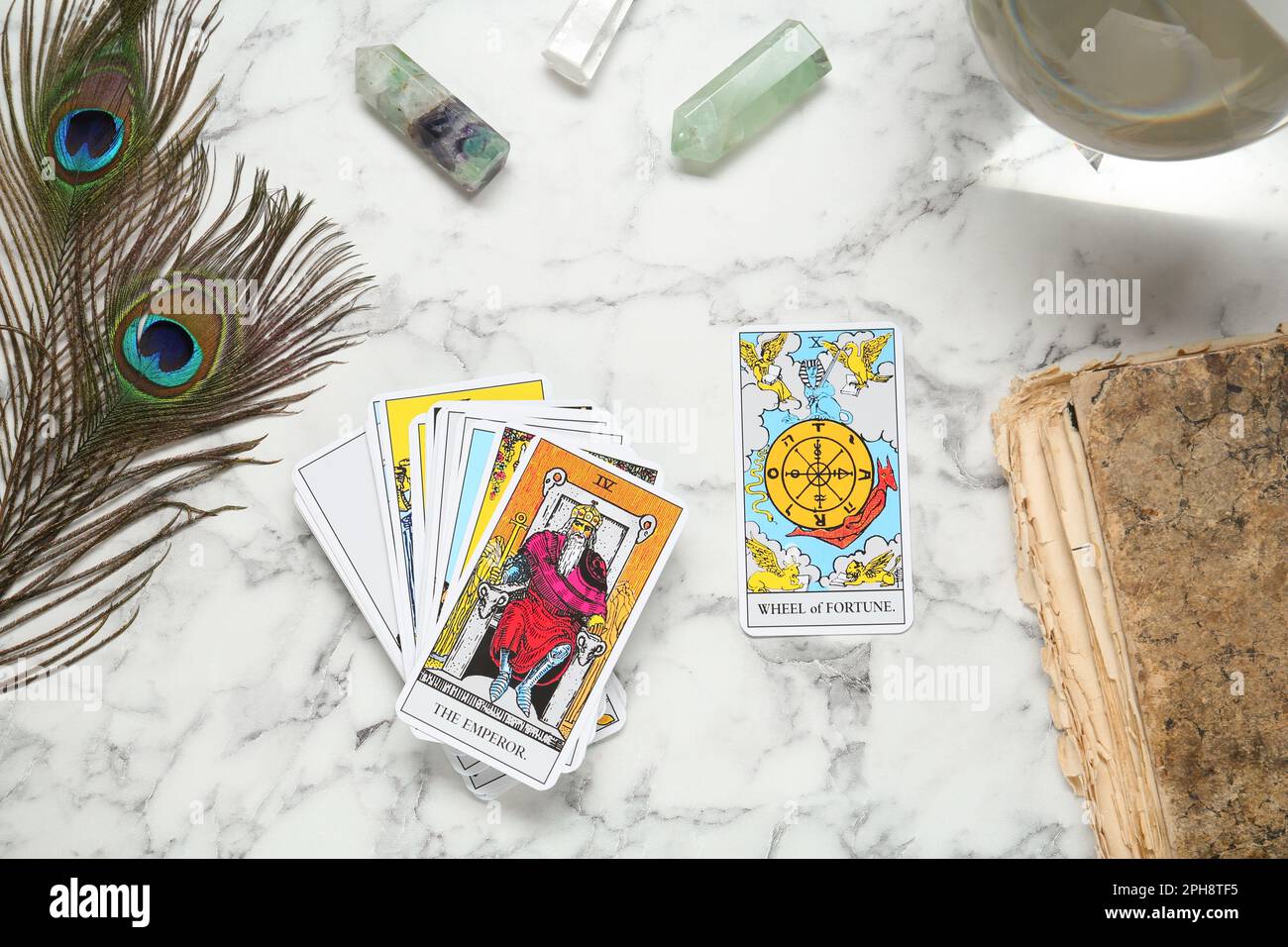 Flat lay composition with Emperor, Wheel of Fortune and other tarot cards on white marble table Stock Photo
