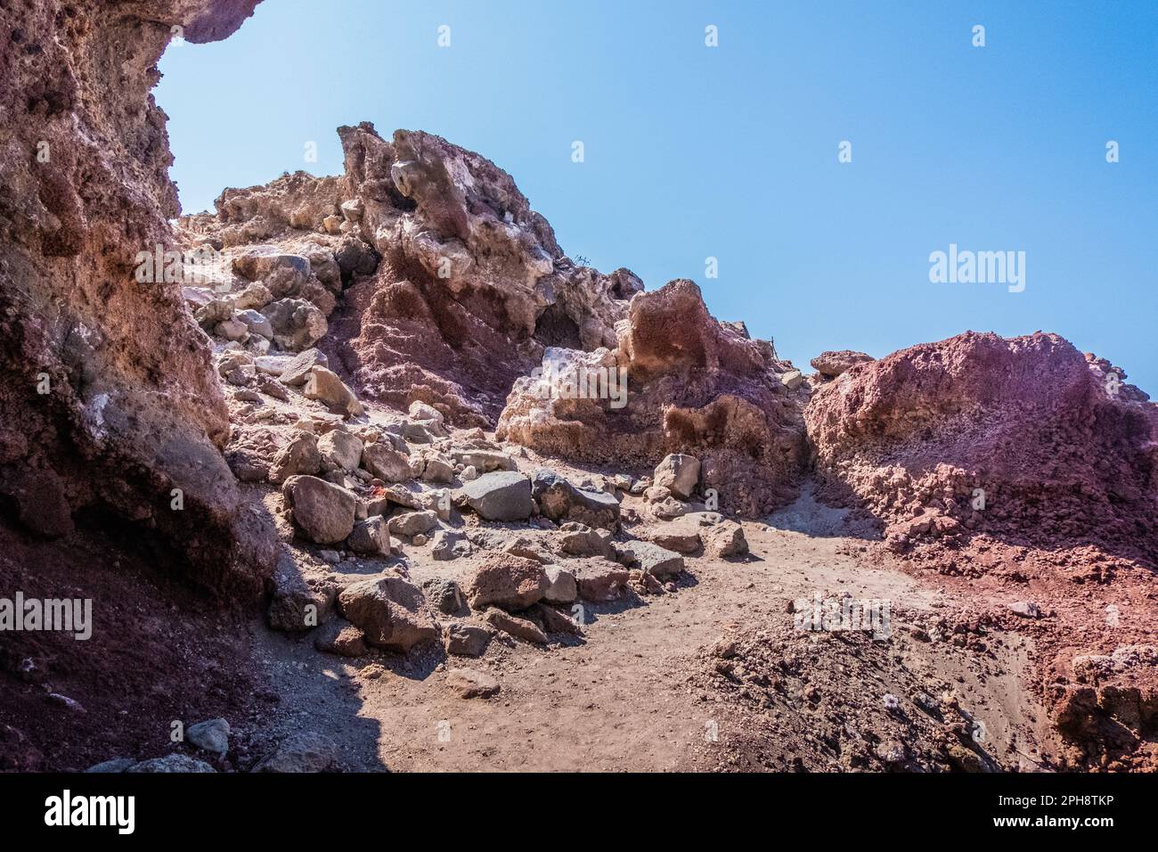 The red earth of the rocky coast of the red beach in santorini Stock ...