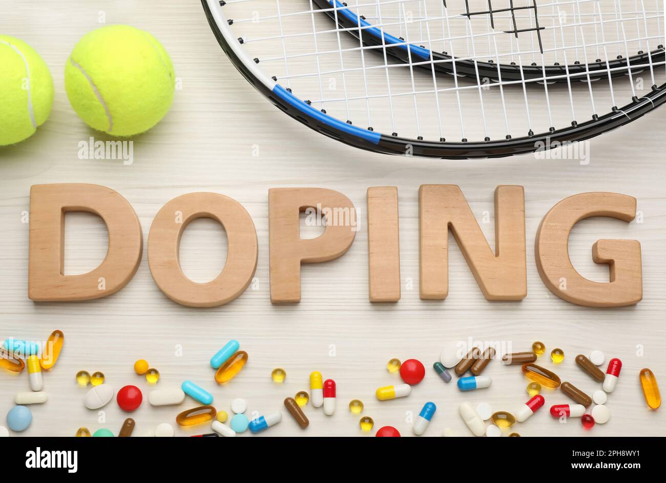 Flat lay composition with word Doping, tennis balls and drugs on white