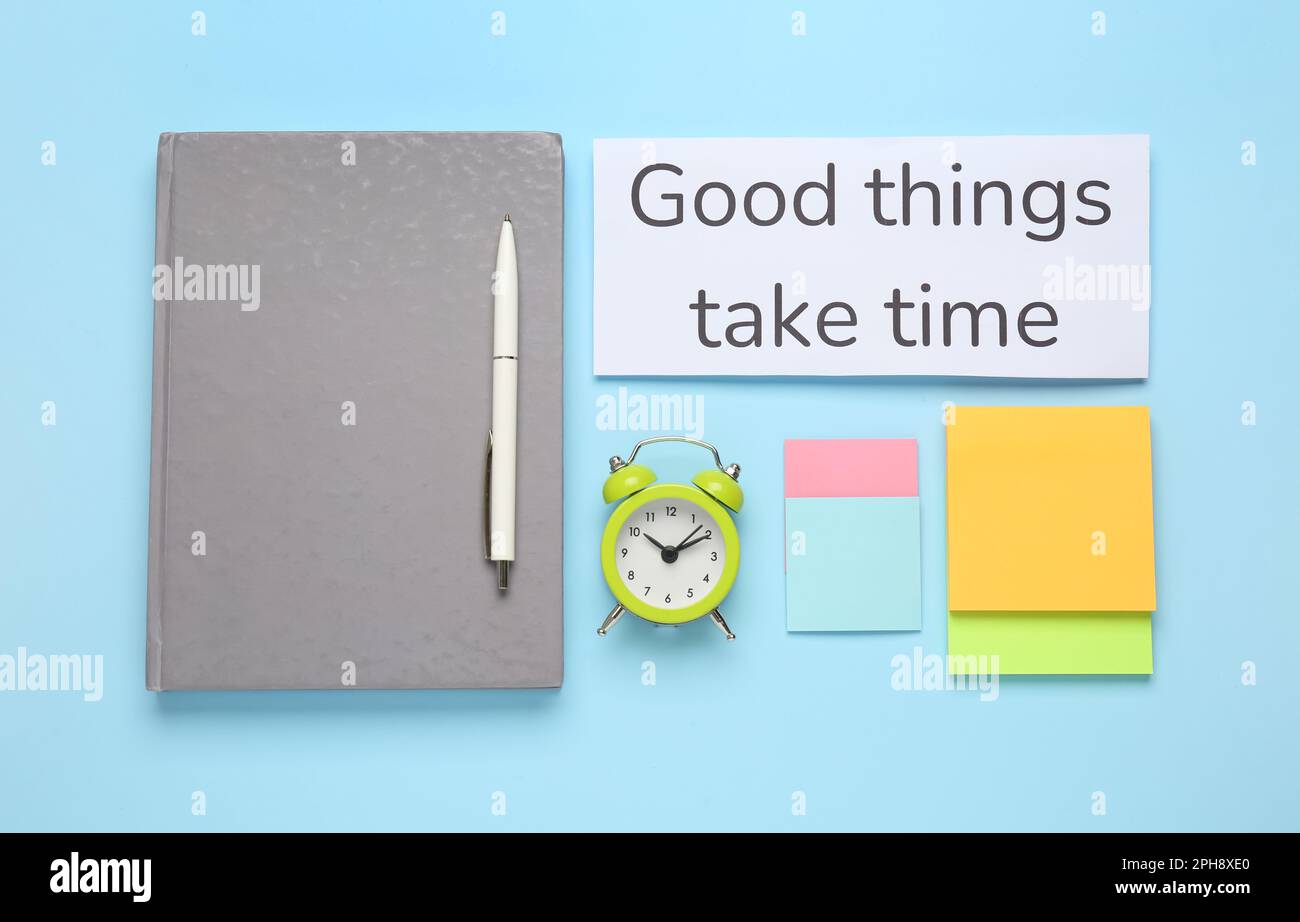 Different stationery, alarm clock and card with motivational quote Good ...