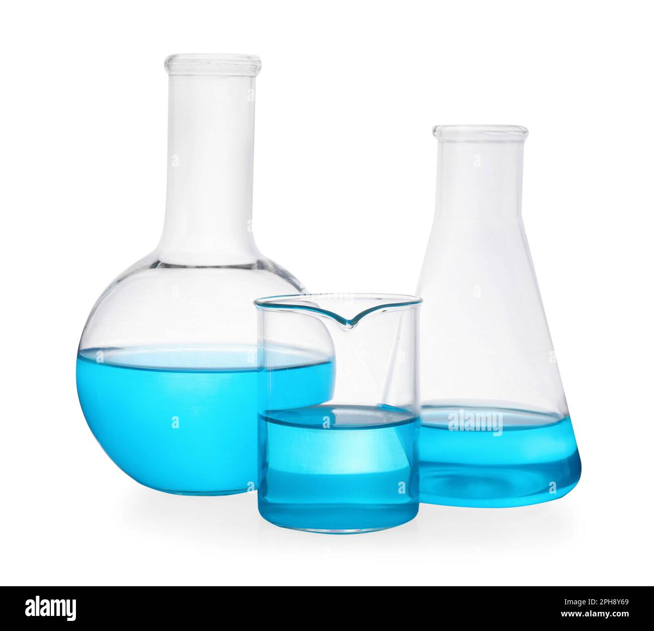 Different laboratory glassware with light blue liquid on white ...