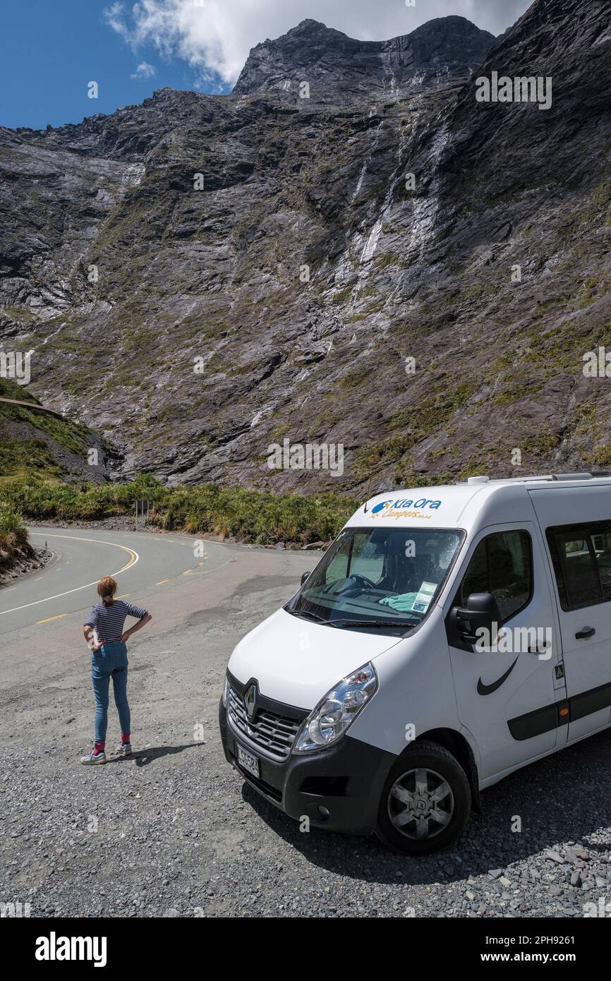 A campervanner stops to look at the view after going through the Homer Tunnel on the way to Milford Sound, Fiordland, South Island, New Zealand Stock Photo