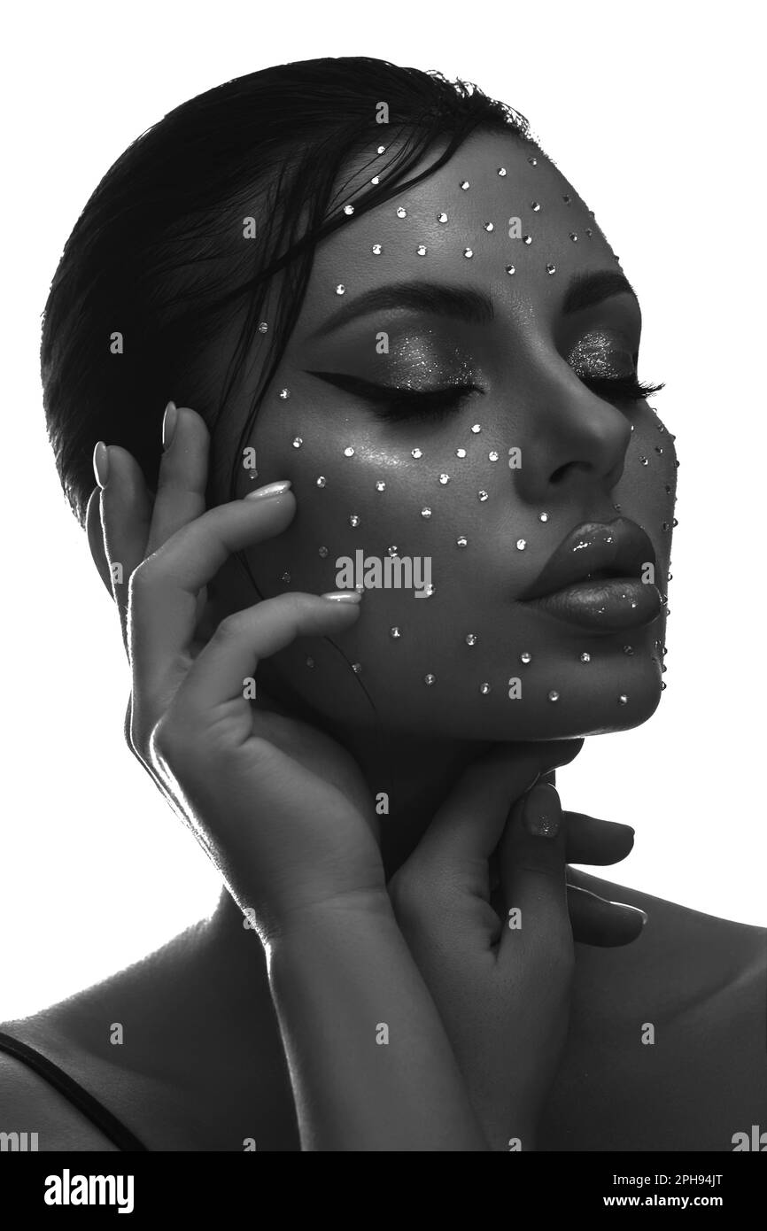 Beauty face woman makeup rhinestones lips. Contrasting portrait of a beautiful woman, wet hair styling. Clean facial skin Stock Photo