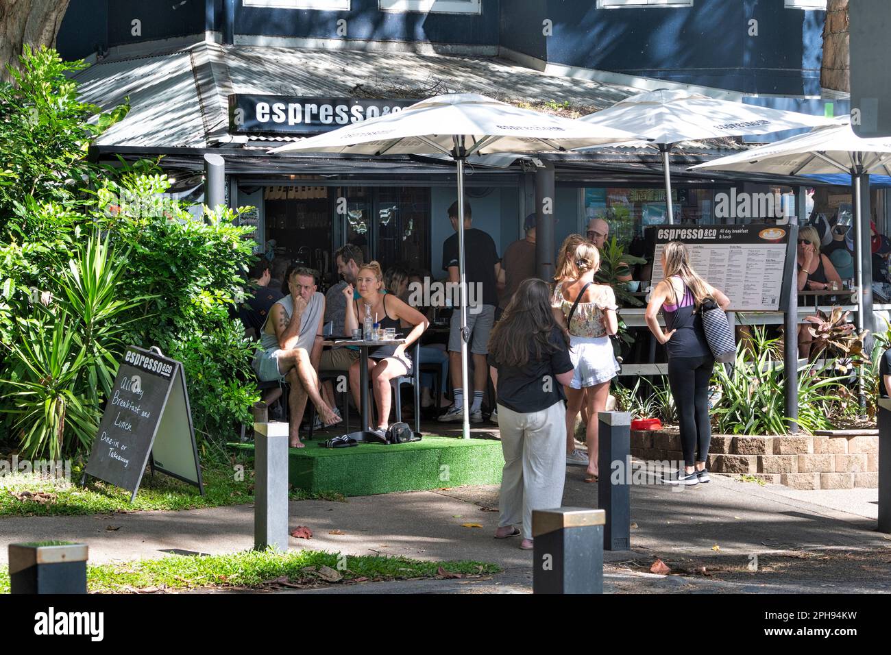Customers waiting and seated at Espresso Coffee Shop on Palm Cove Esplanade, Cairns Northern