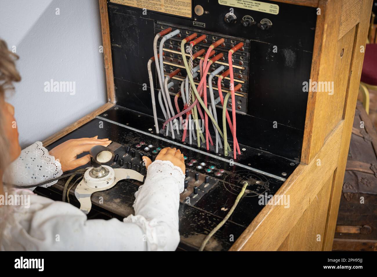 An antique telephone switchboard with multiple cords, buttons, and input ports Stock Photo