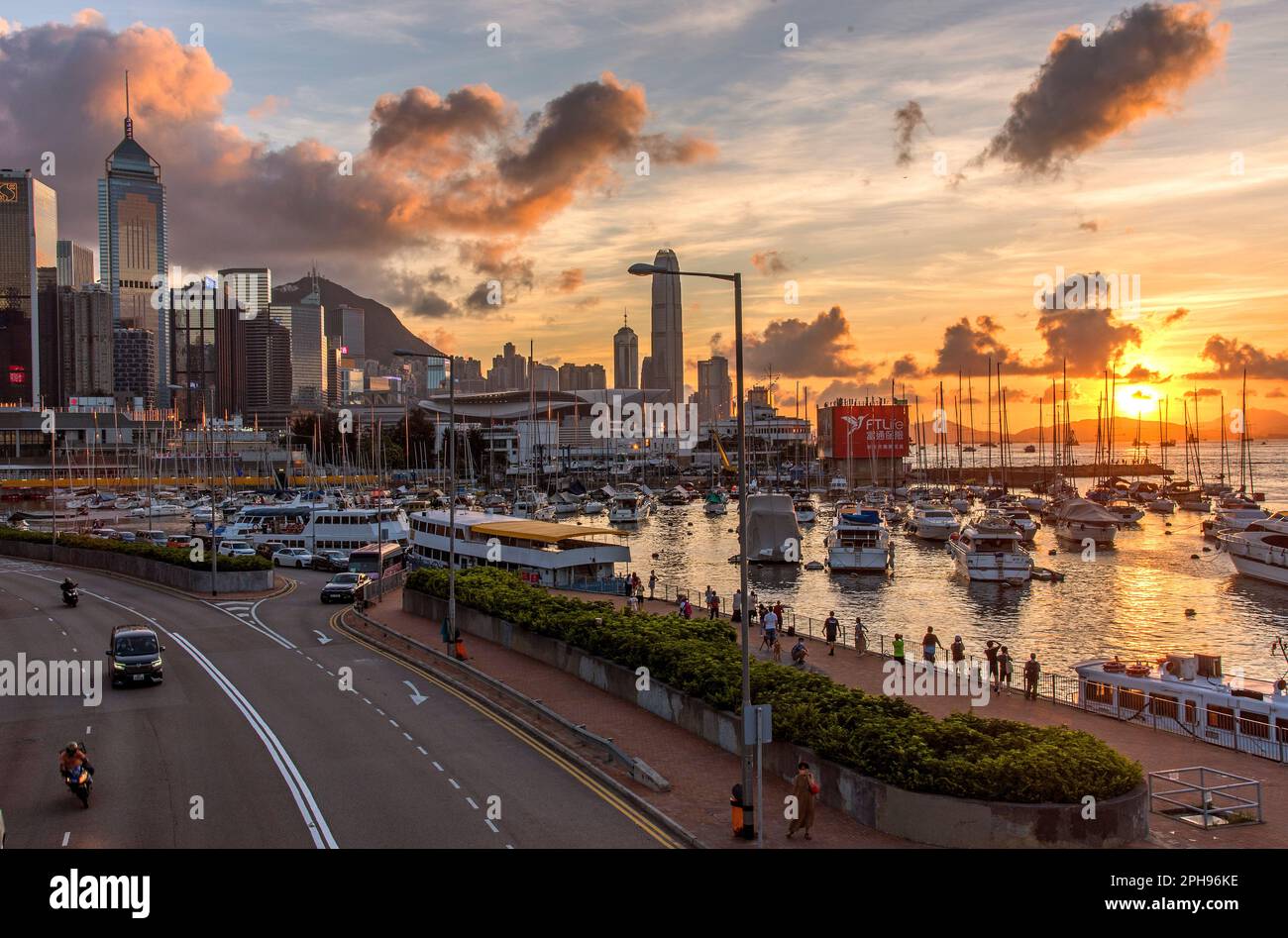View of Causeway Bay Typhoon Shelter and city skyline at sunset from a footbridge near the Noon Day Gun Stock Photo