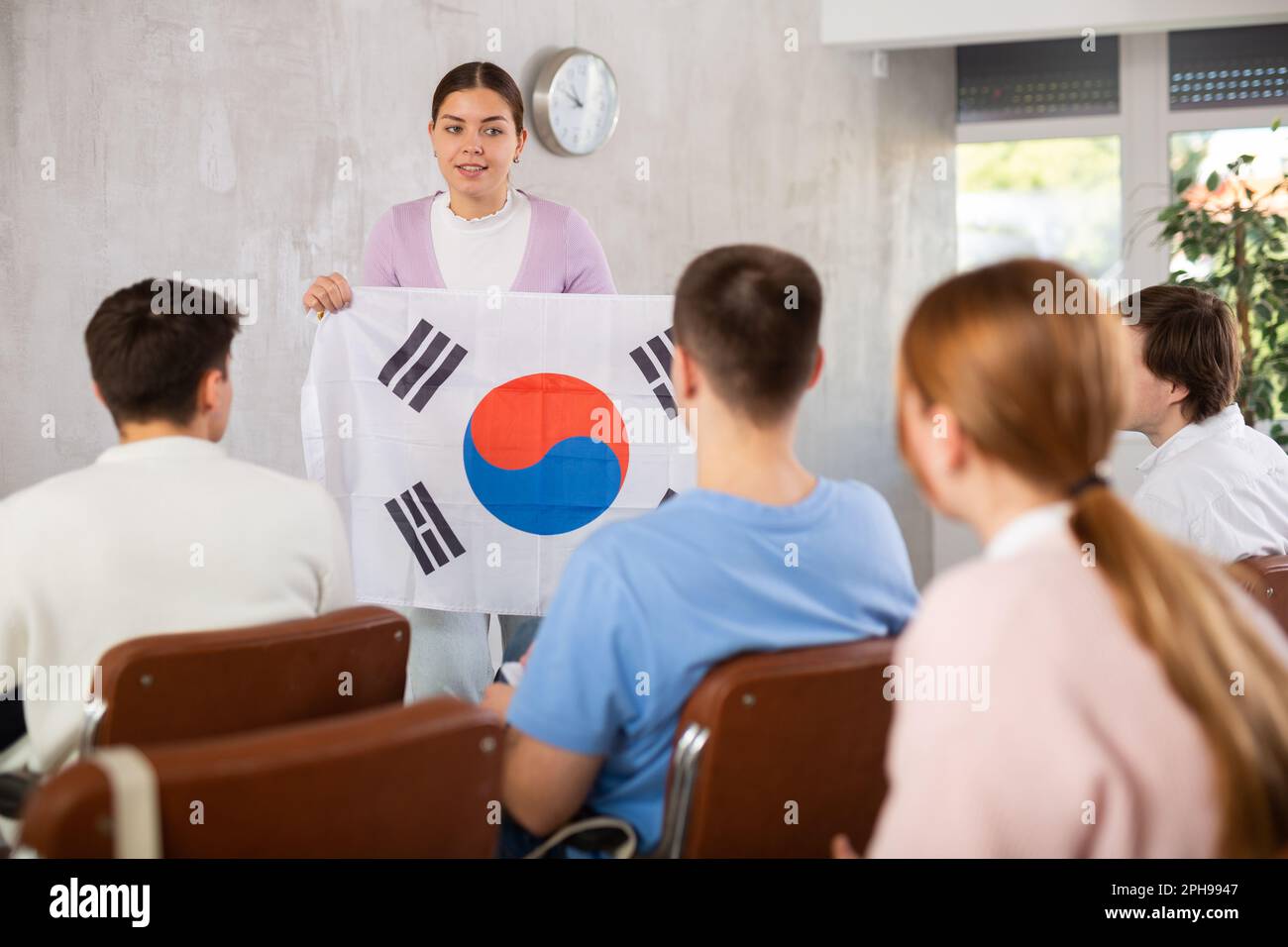 Female teacher tells the history of the state of South Korea, holding