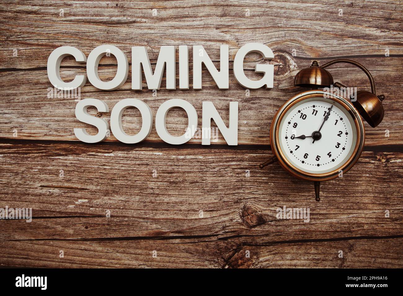 Coming Soon alphabet letter and alarm clock on wooden background Stock Photo Alamy