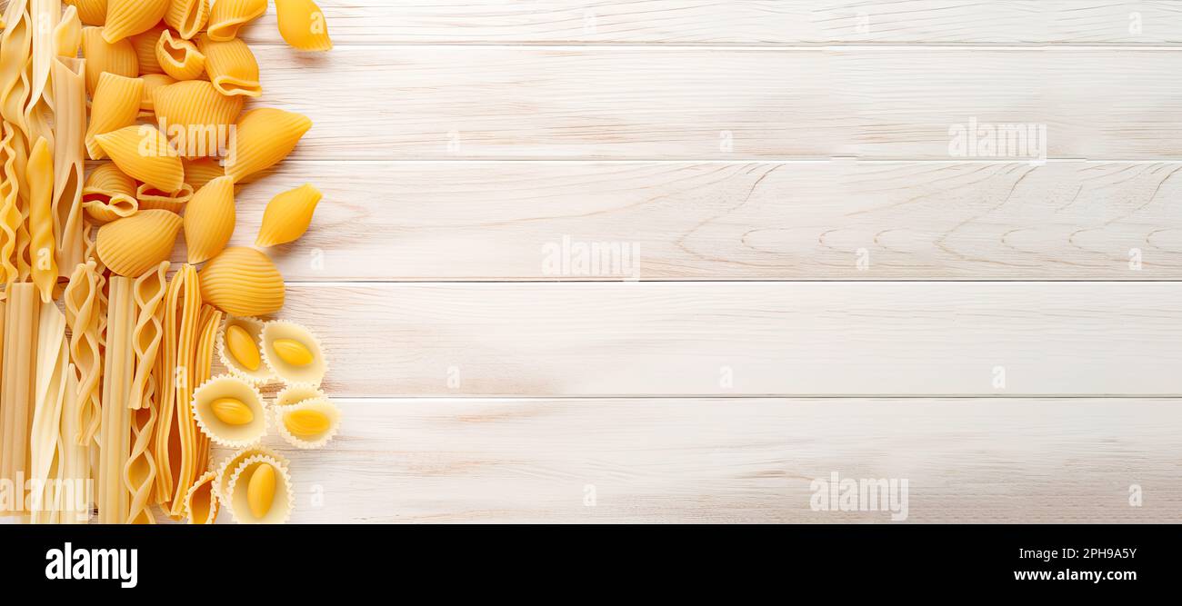 Assorted raw Italian pasta on a white wood background, with and large ...