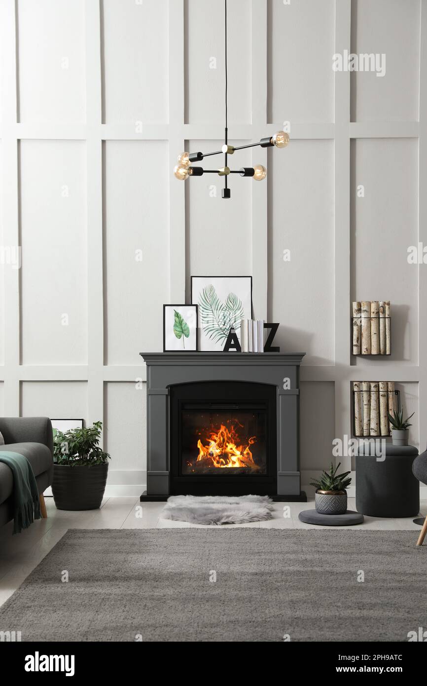Stylish living room interior with electric fireplace and decor elements ...