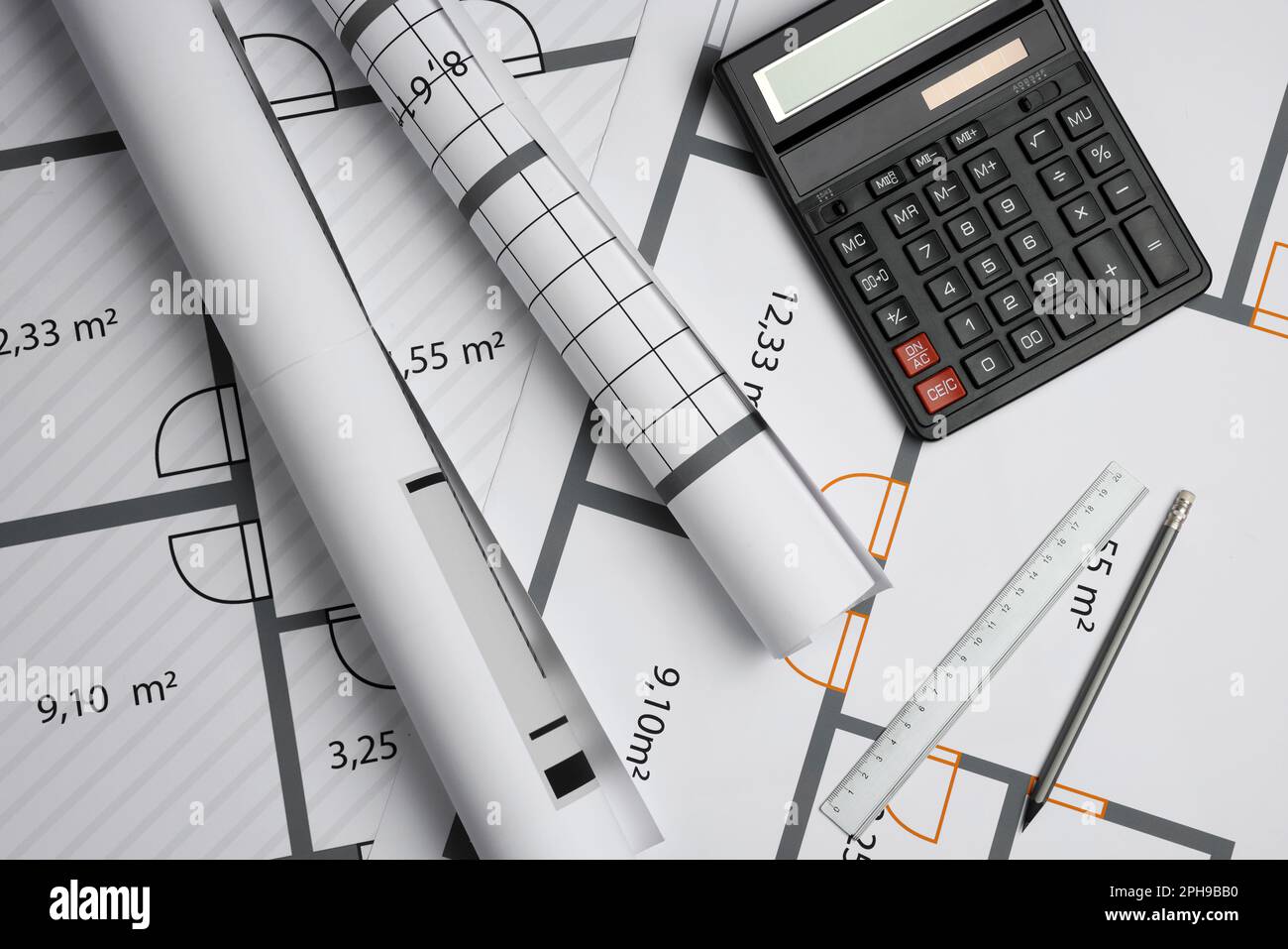 Construction drawings, ruler, pencil and calculator on house plan, flat