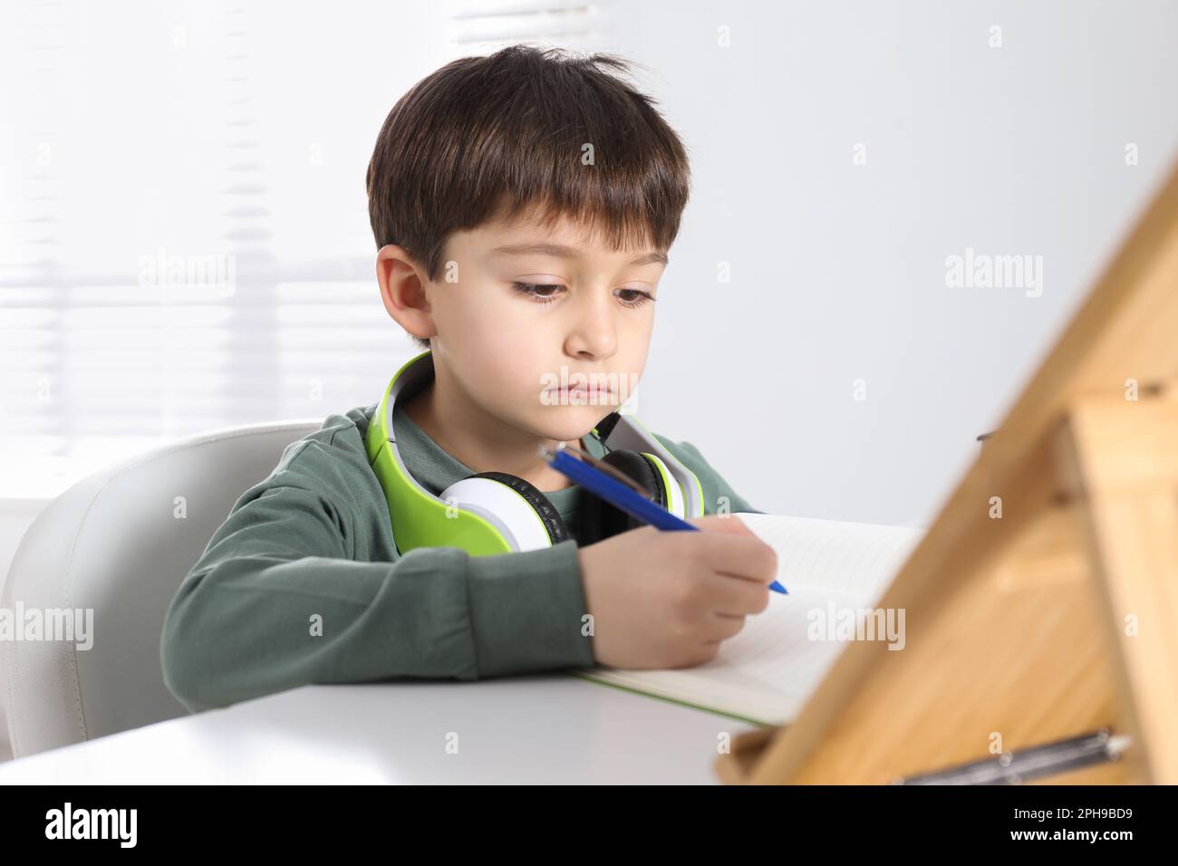 Cute little boy with modern tablet studying online at home. E-learning ...