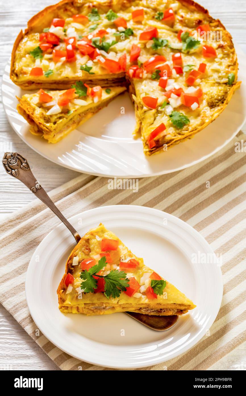 Green Chile Enchilada Casserole of corn tortillas layered with refried