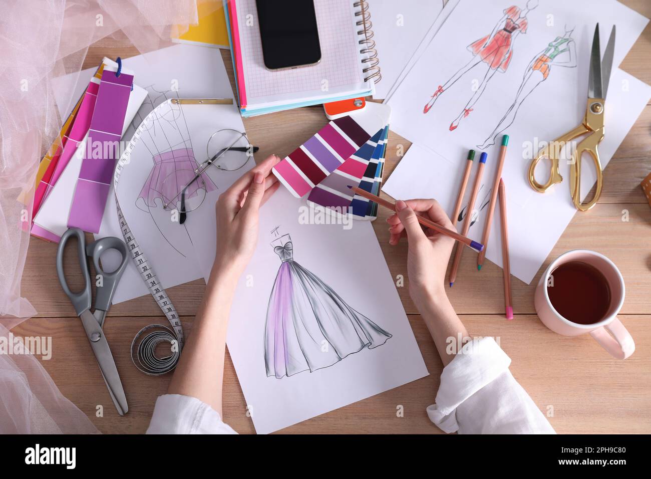 Fashion designer drawing sketch at wooden table, top view Stock Photo ...