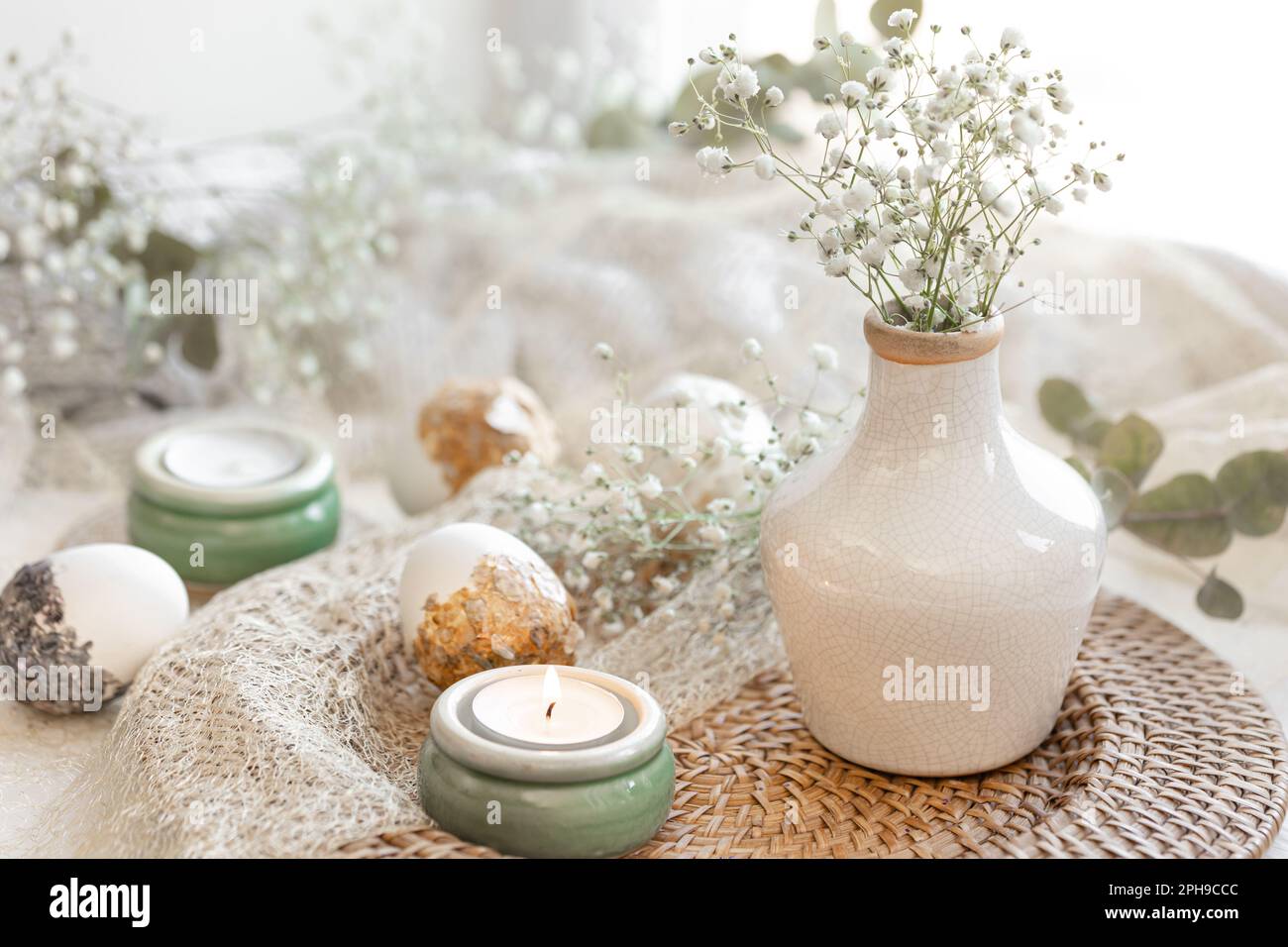 Easter composition with gypsophila flowers and Easter eggs. Stock Photo