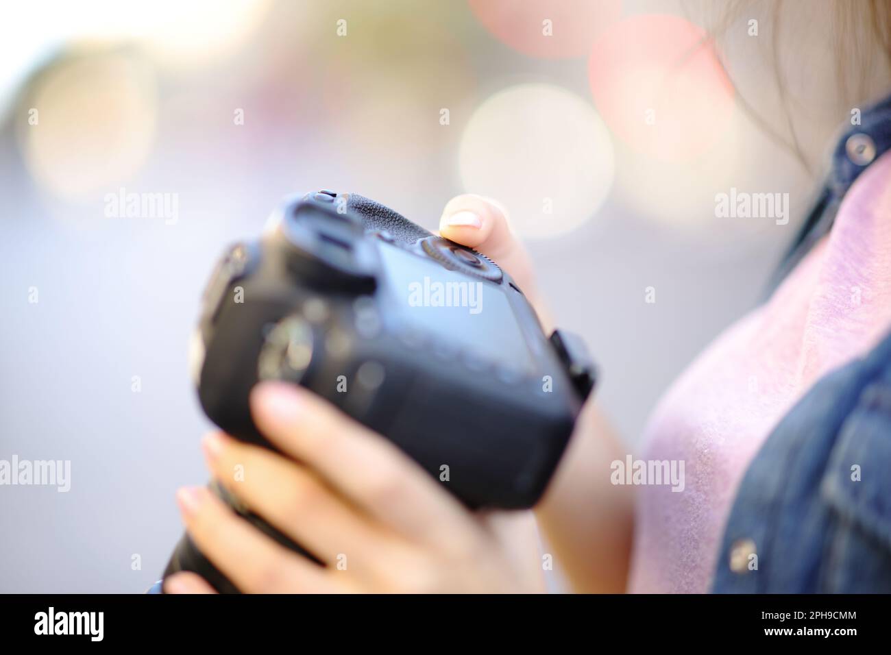 Close up of a photographer hand setting camera in the street Stock Photo
