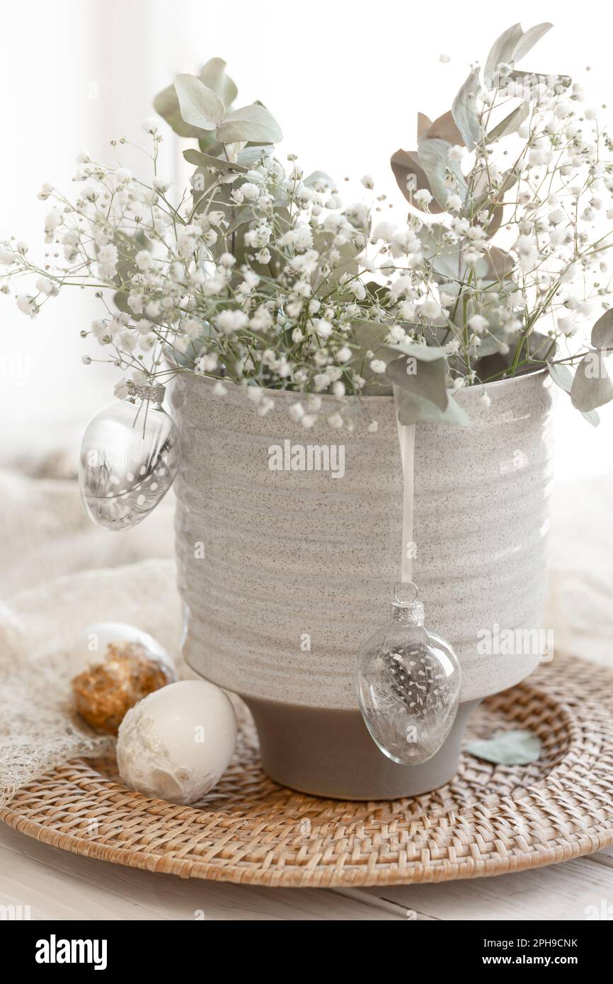Light Easter composition with Easter eggs and gypsophila flowers. Stock Photo