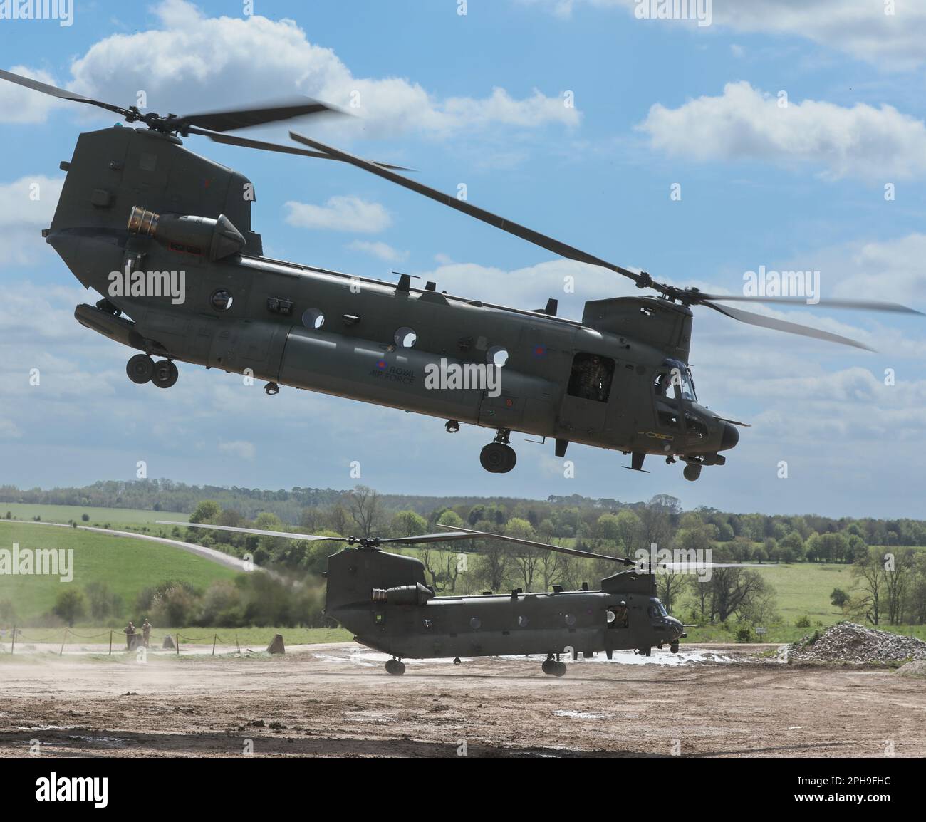 Two CH47 Chinook helicopters operated by the RAF getting airborne from
