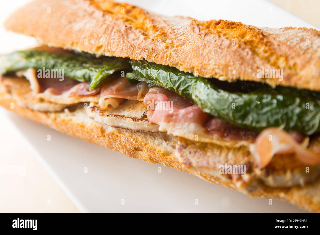 Serranito Sandwich. Typical Spanish sandwich with pork loin, bacon and