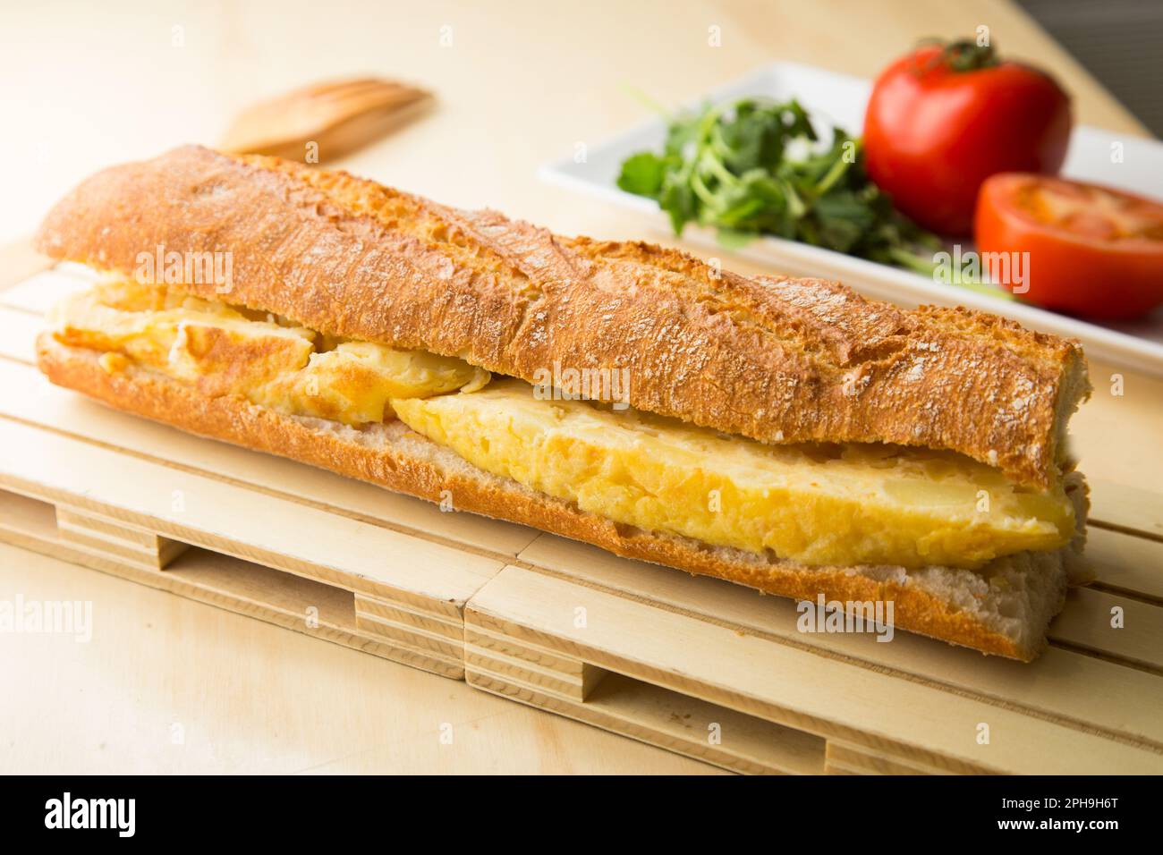 Delicious sandwich with spanish omelette with egg and potatoes. Stock Photo