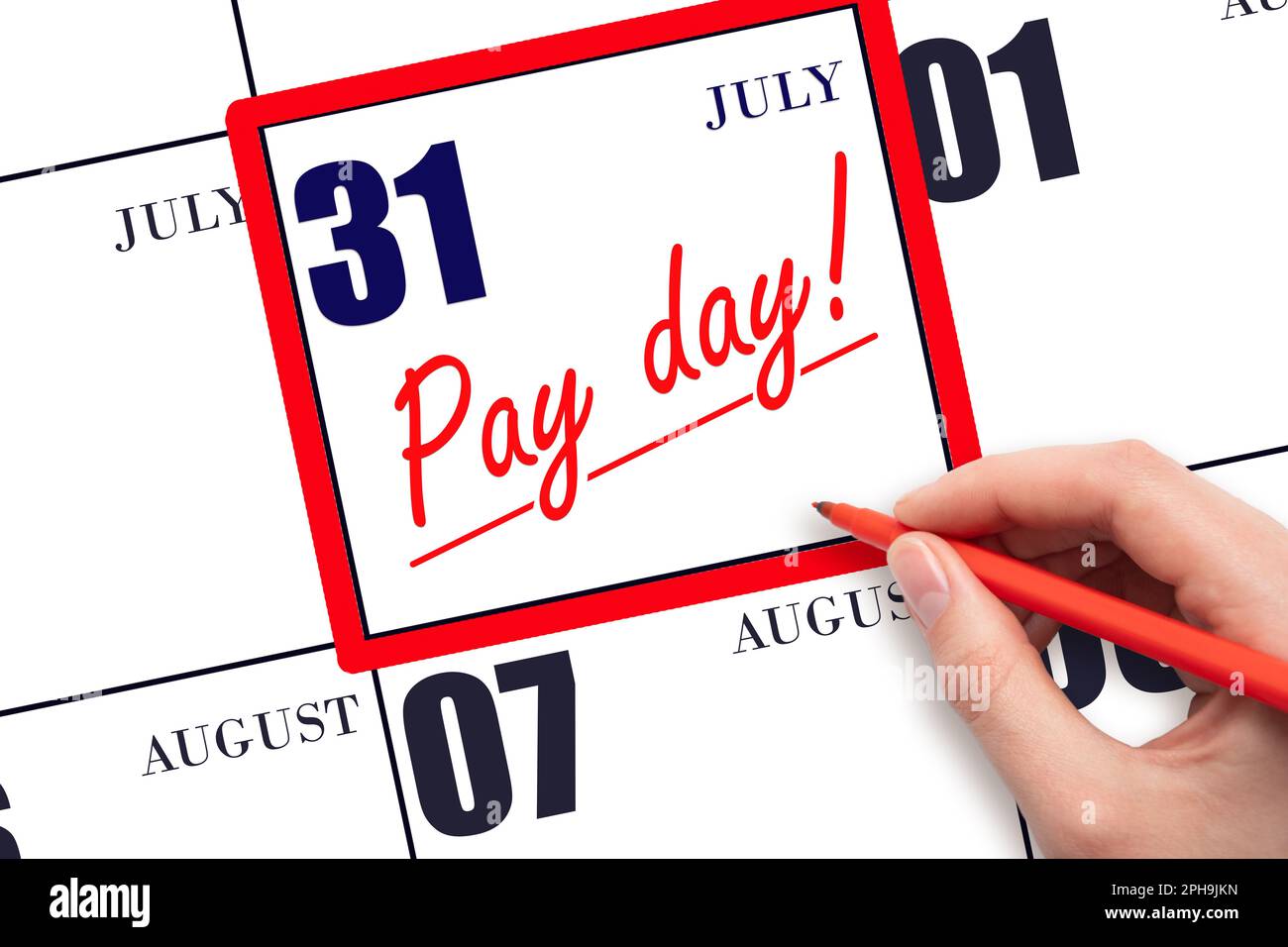 31st day of July. Hand writing text PAY DATE on calendar date July 31 and underline it. Payment due date.  Reminder concept of payment. Summer month, Stock Photo