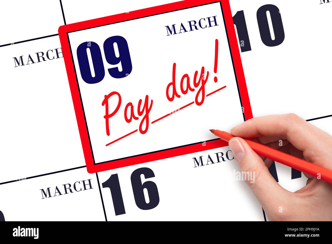 9th day of March. Hand writing text PAY DATE on calendar date March 9 and underline it. Payment due date.  Reminder concept of payment. Spring month, Stock Photo