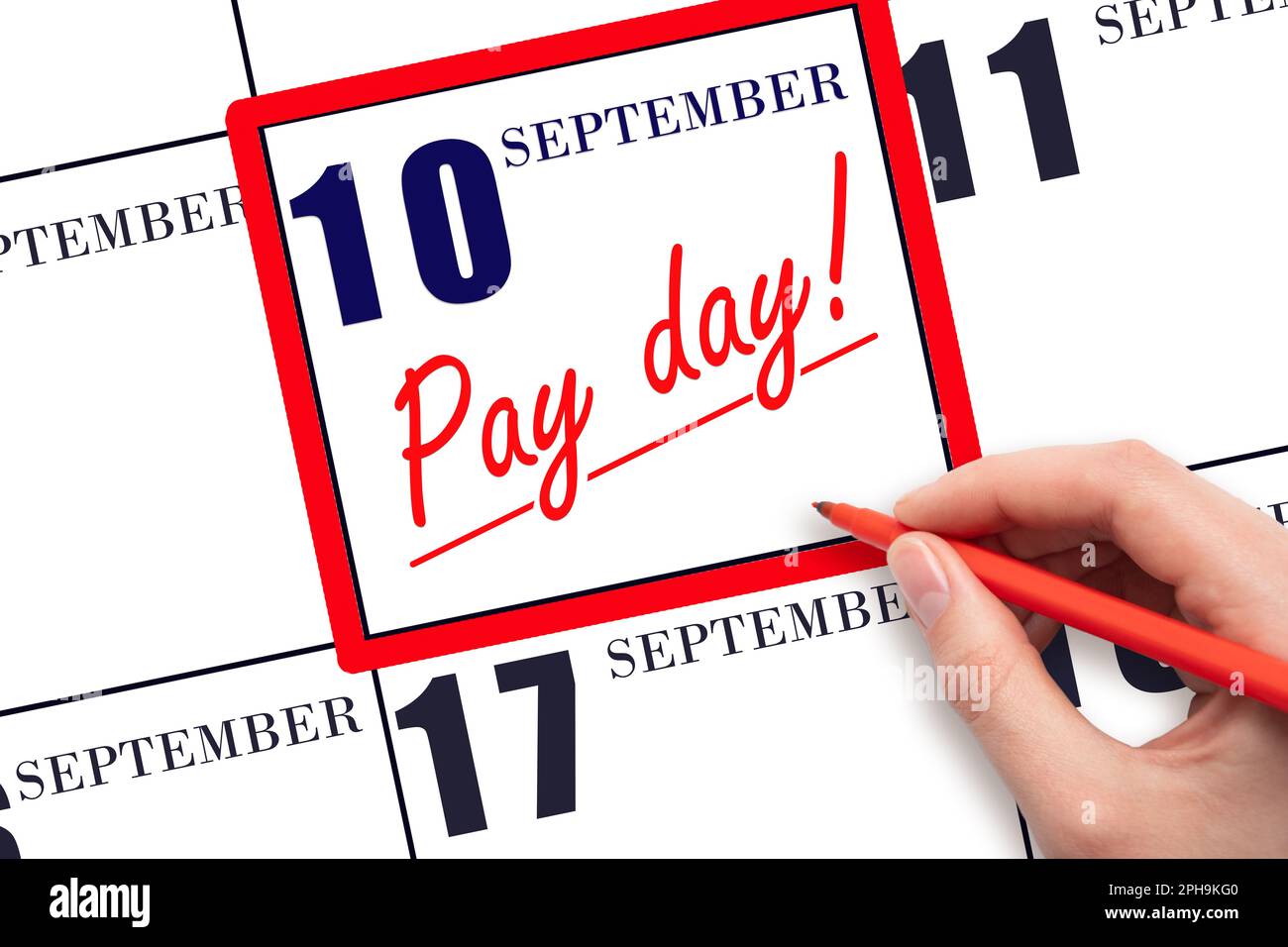 10th day of September. Hand writing text PAY DATE on calendar date September  10 and underline it. Payment due date.  Reminder concept of payment. Aut Stock Photo