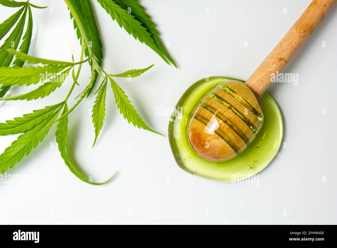 Cannabis honey and a wooden dipper spoon isolated Stock Photo
