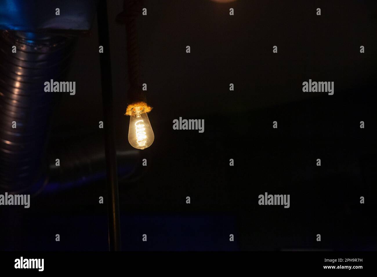 Picture of lightbulbs hnging from the roof, lighting and shining with a