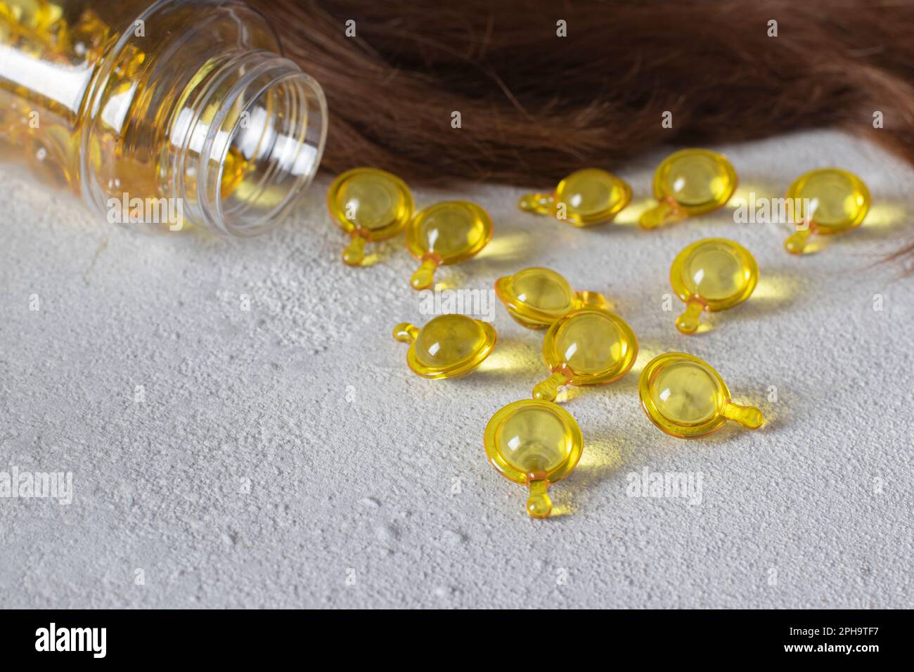Hair Vitamin Capsules on Gray Background Hair Treatment and Care