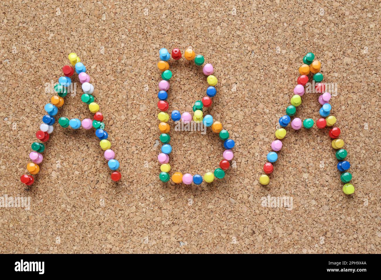 Applied behavior analysis concept. Corkboard with abbreviation ABA made