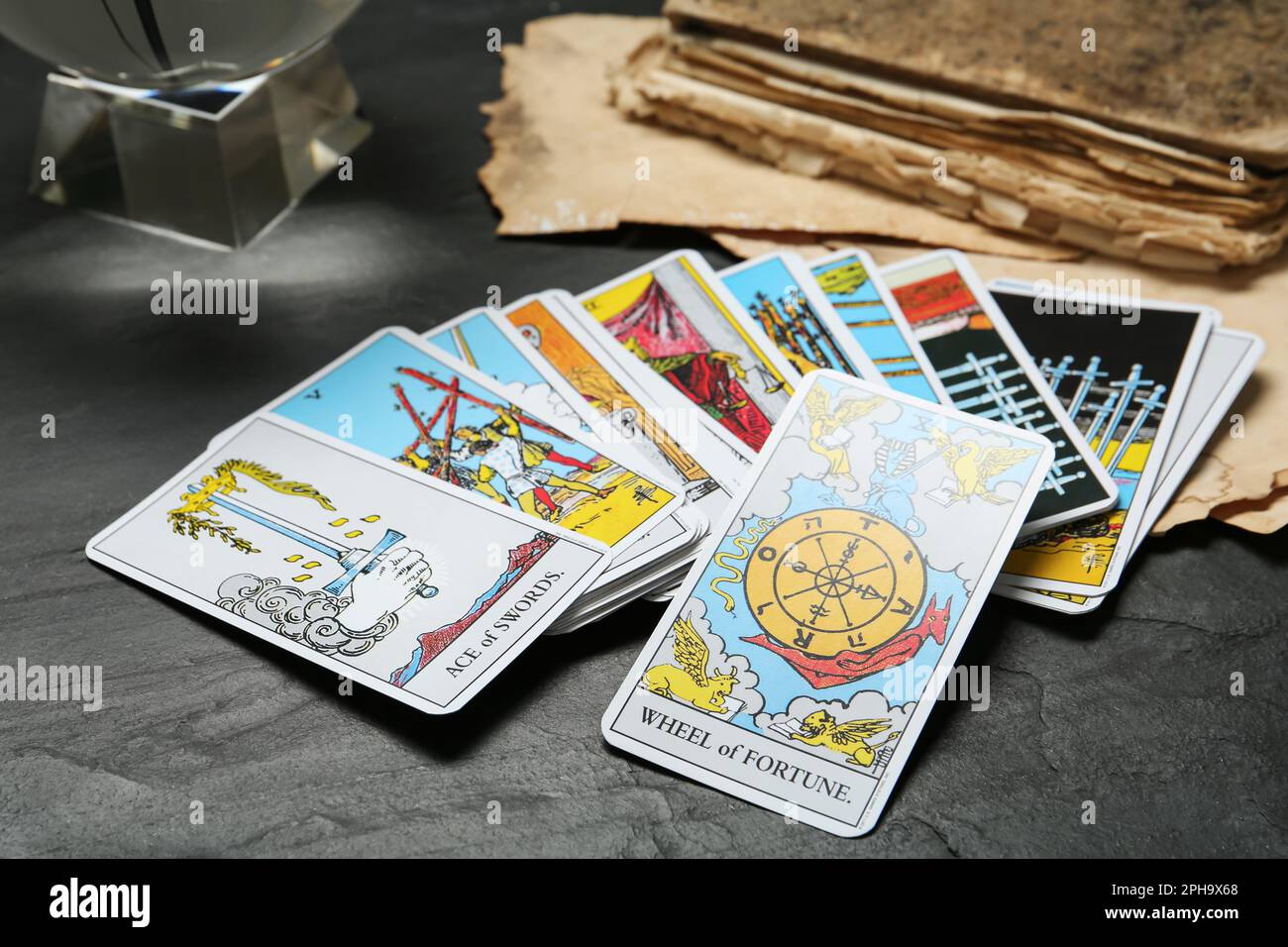 Wheel of Fortune and other tarot cards on black table Stock Photo