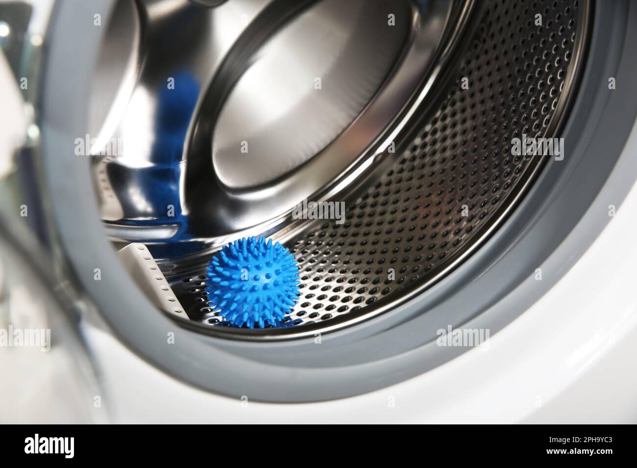 Blue dryer ball in washing machine drum, closeup Stock Photo Alamy