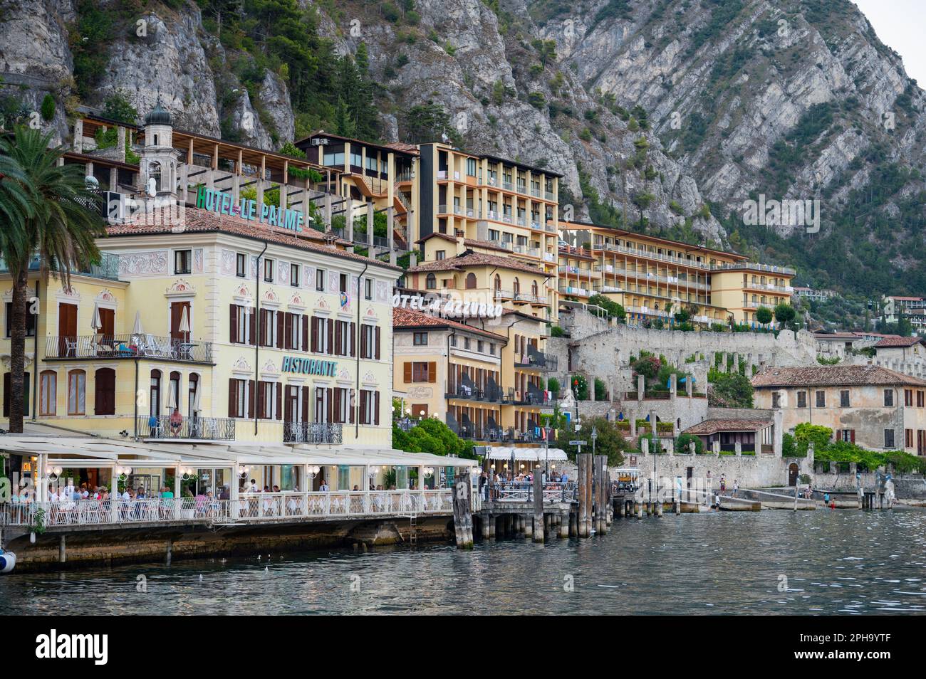 Water front buildings looking out from Limone Sul Garde, a popular town on the shore of Lake Garda, Italy Stock Photo
