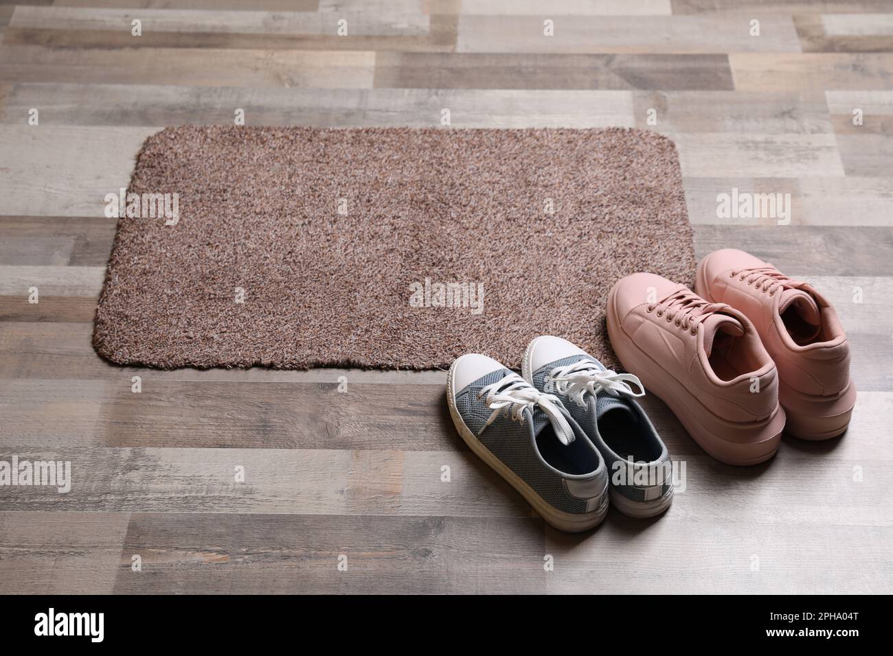 New clean door mat and shoes on floor Stock Photo Alamy