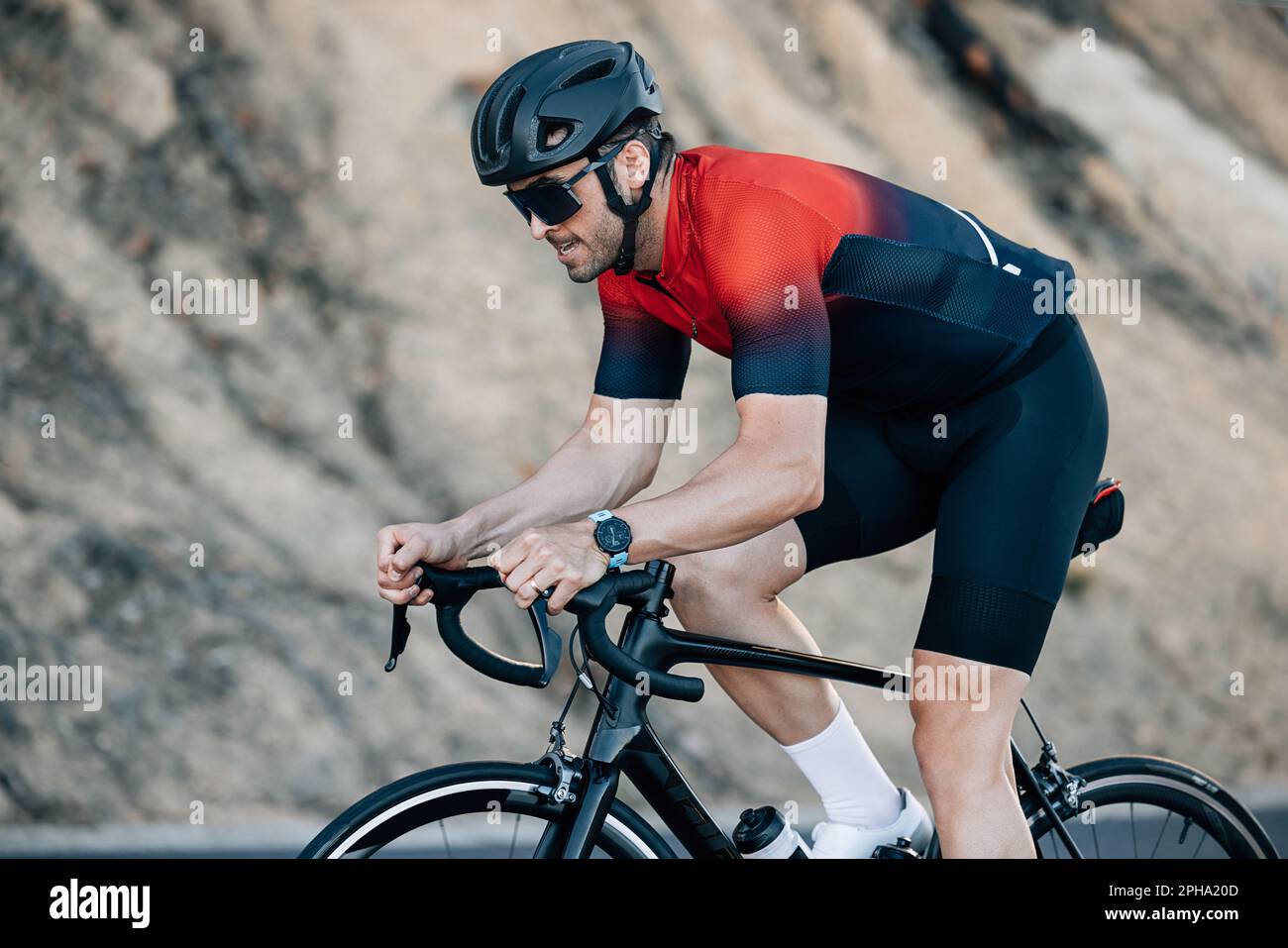 Male cyclist in helmet and glasses doing intense ride outdoors. Cyclist ...