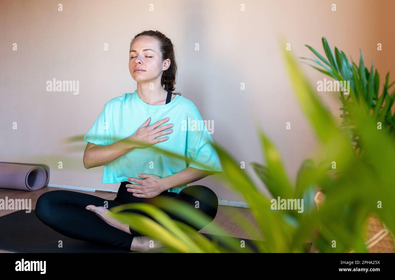 Woman doing yoga breathing exercise. Stock Photo