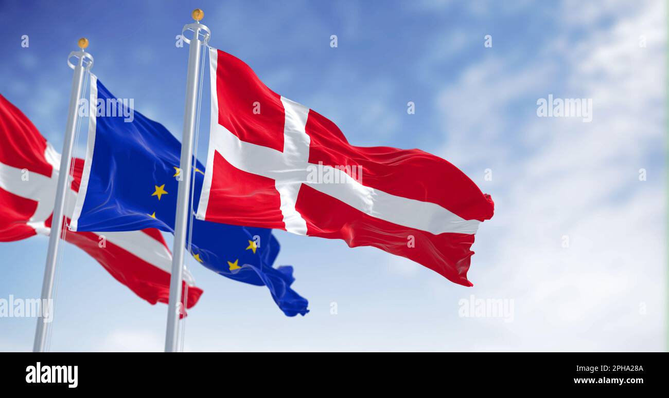 The flags of Denmark and the European Union waving together on a clear day. Denmark became a member of the European Union on January 1, 1973. Realisti Stock Photo
