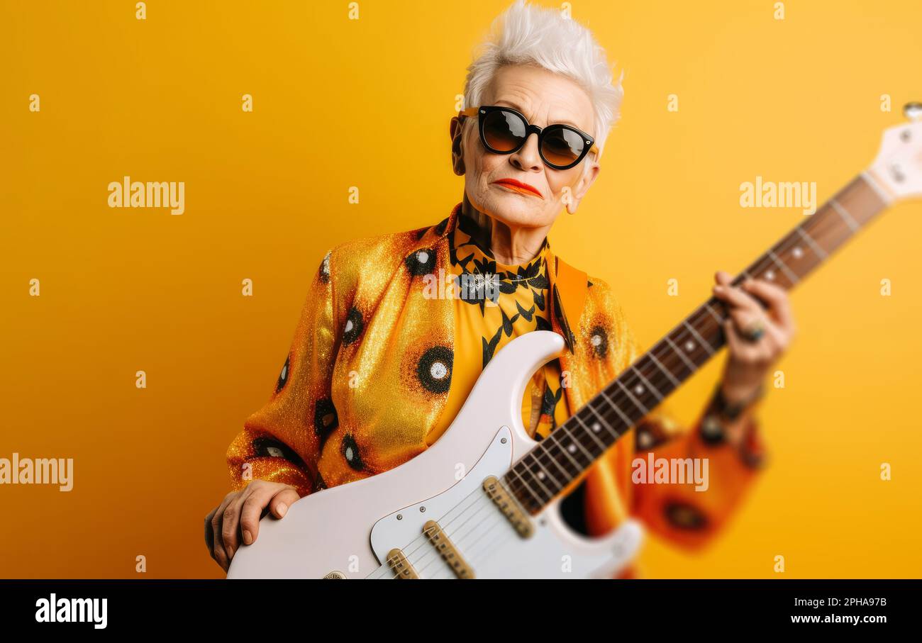 Portrait of a cool trendy old woman playing a guitar. Generative ai Stock Photo