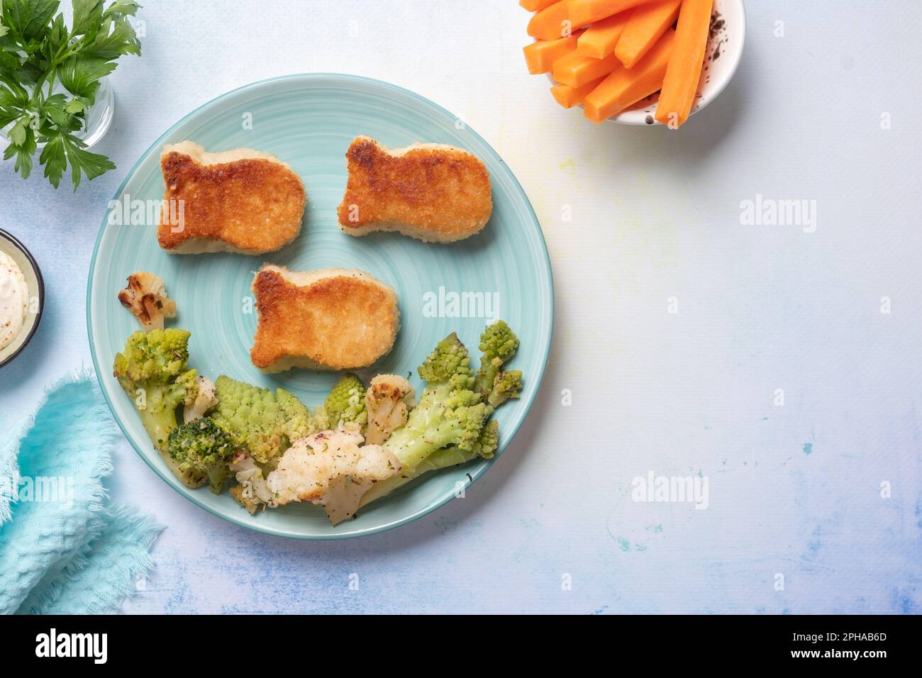 Kids food. Fish shaped nuggets with vegetable, ready to eat Stock Photo