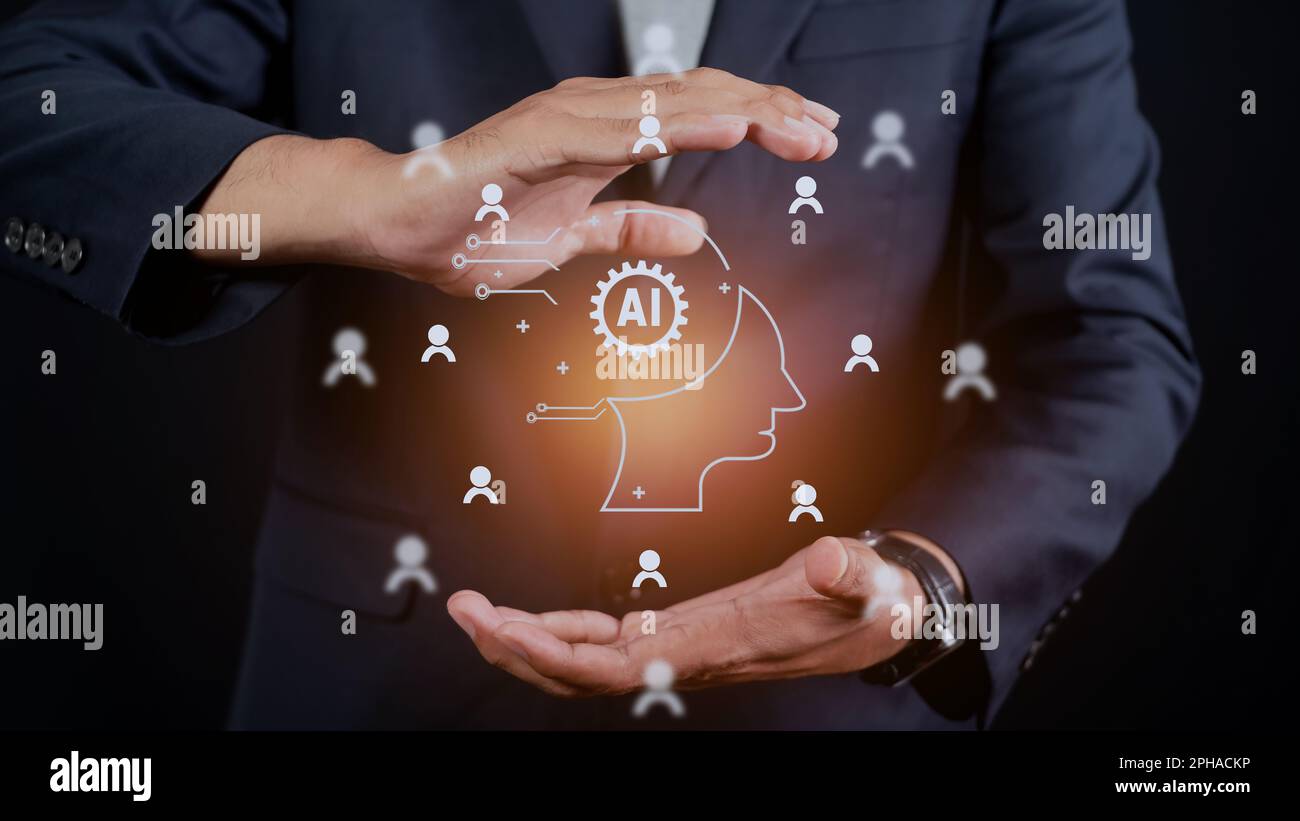 Concept of artificial intelligence or AI in business. Man holding smart robot technology icon. Futuristic technological transformation Stock Photo