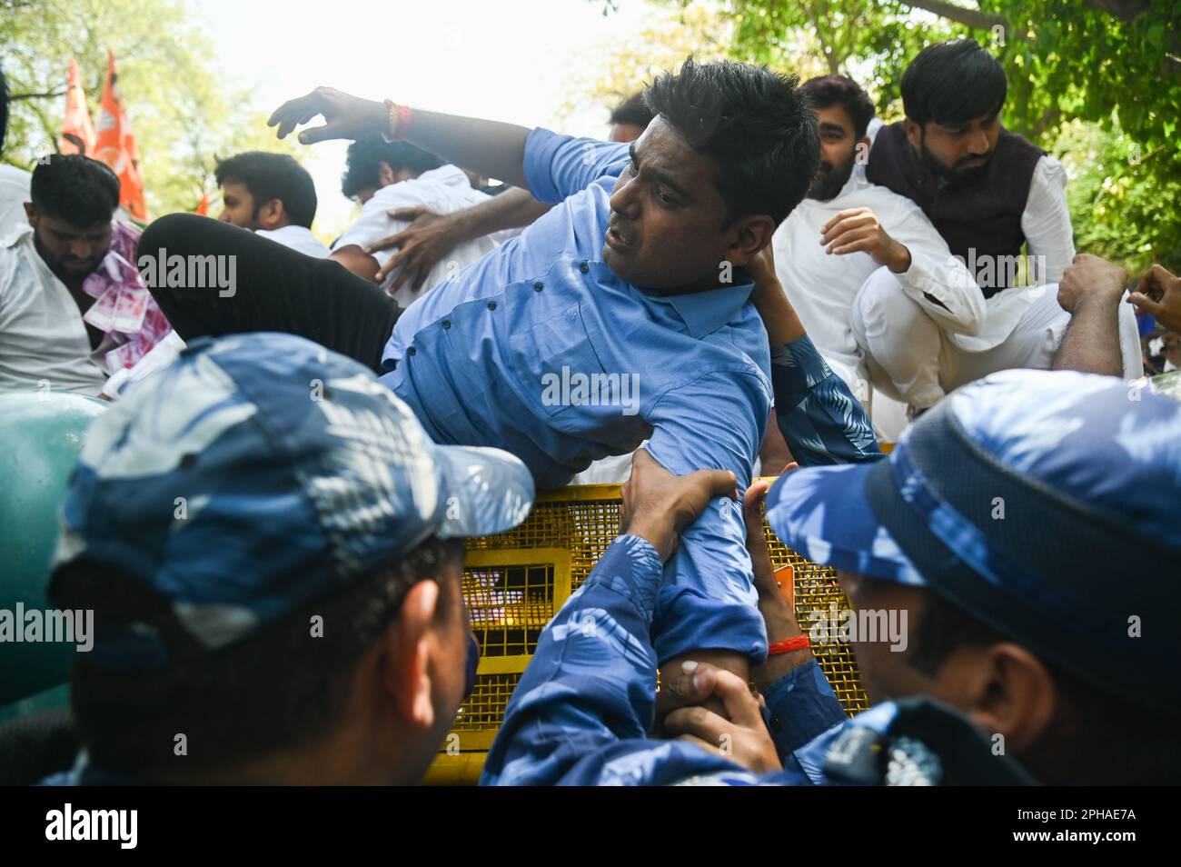 New Delhi, Delhi, India. 27th Mar, 2023. Police officers detain a supporter of Indian Youth congress after a protest against the disqualification from the Indian Parliament of India's main opposition leader of the Indian National Congress, Rahul Gandhi, in New Delhi, India on March 27, 2023. Rahul Gandhi was disqualified from the Indian Parliament, a day after a Indian Court convicted him in a defamation case and sentenced him to two years in prison. (Credit Image: © Kabir Jhangiani/ZUMA Press Wire) EDITORIAL USAGE ONLY! Not for Commercial USAGE! Credit: ZUMA Press, Inc./Alamy Live News Stock Photo