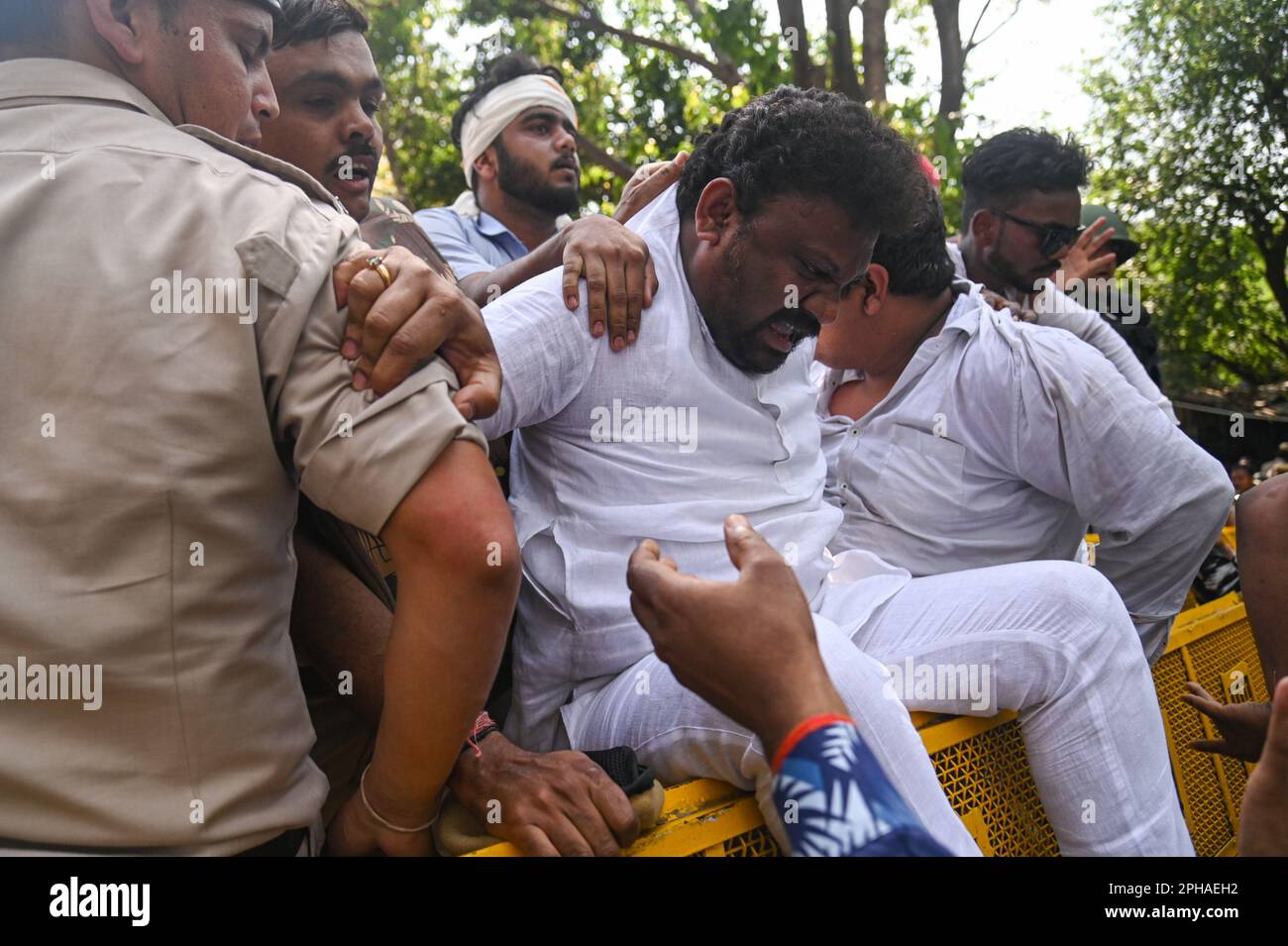 New Delhi, Delhi, India. 27th Mar, 2023. Police officers detain a supporter of Indian Youth congress after a protest against the disqualification from the Indian Parliament of India's main opposition leader of the Indian National Congress, Rahul Gandhi, in New Delhi, India on March 27, 2023. Rahul Gandhi was disqualified from the Indian Parliament, a day after a Indian Court convicted him in a defamation case and sentenced him to two years in prison. (Credit Image: © Kabir Jhangiani/ZUMA Press Wire) EDITORIAL USAGE ONLY! Not for Commercial USAGE! Credit: ZUMA Press, Inc./Alamy Live News Stock Photo