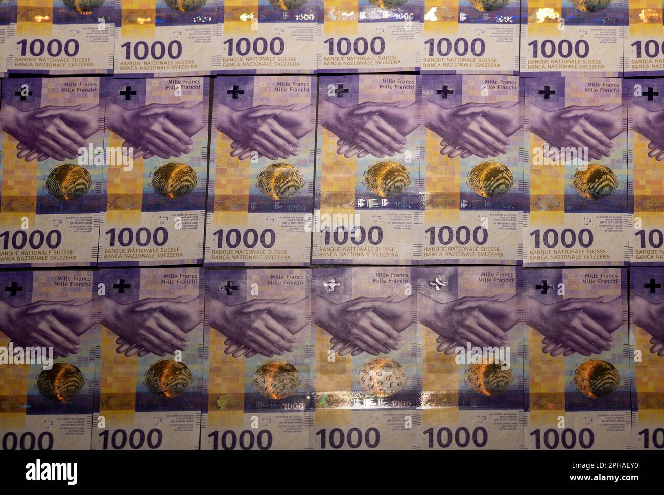 Illuminating Many 1000 Swiss Franc Banknote on Table in Switzerland. Stock Photo