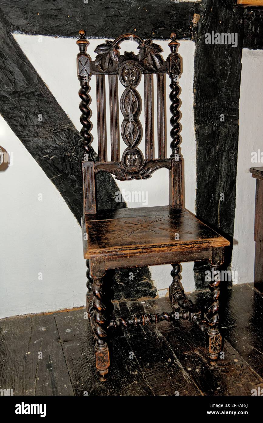 Old chair, antique wooden oak vintage furniture at Tudor House Museum Worcester, Worcestershire, England, United Kingdom - 28th of January 2023 Stock Photo