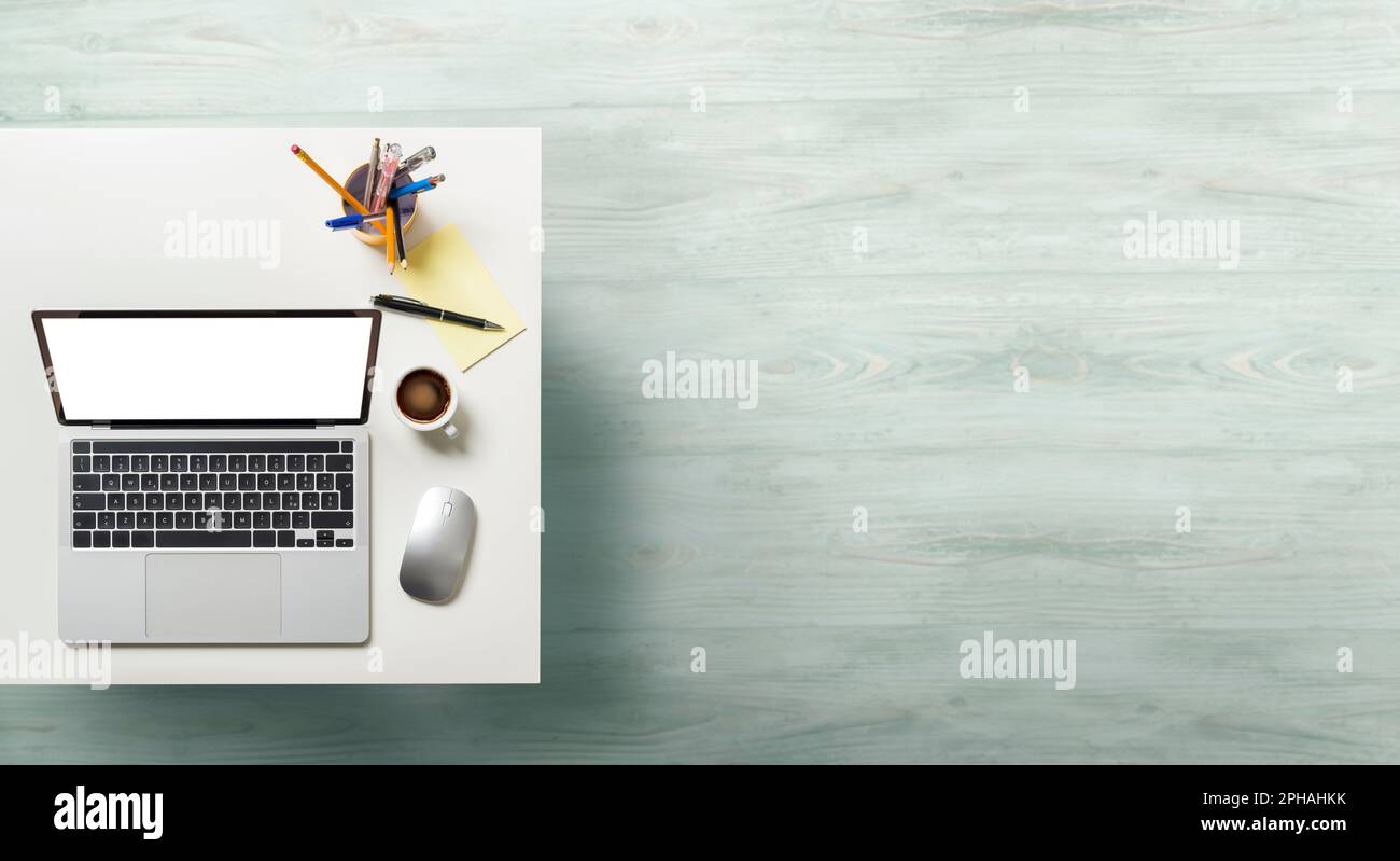 Laptop with white screen on office table. Top view with empty copy space. Stock Photo