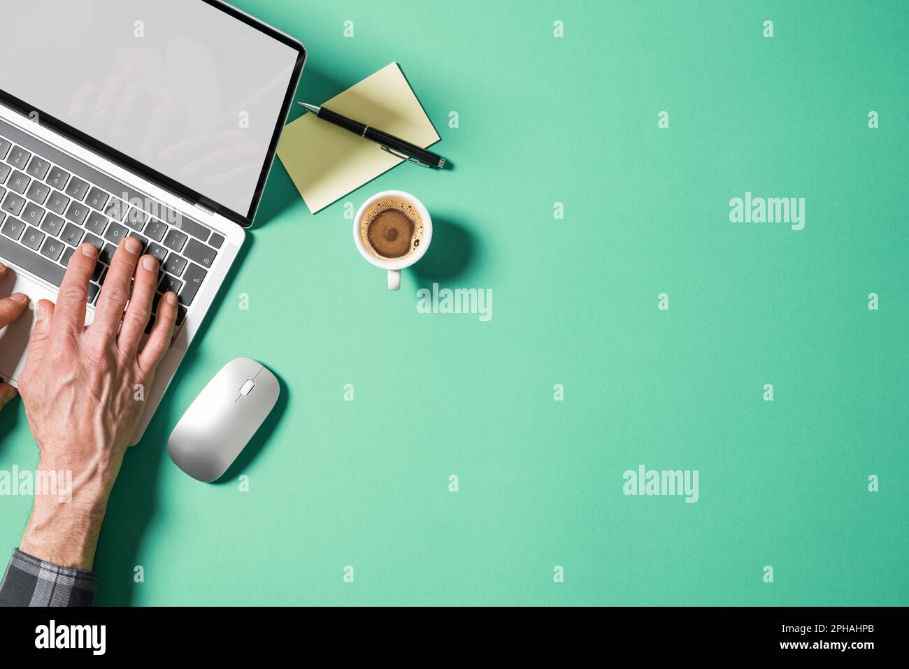 Hands of man over laptop with blank screen. Top view with empty copy space. Stock Photo