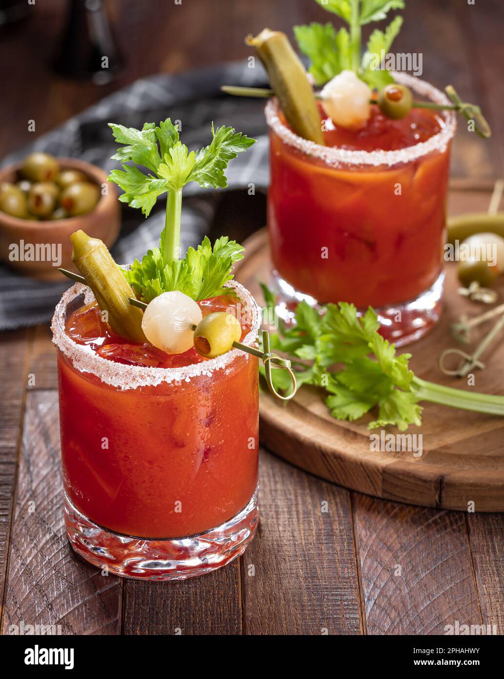 Bloody mary cocktail garnished with celery, okra, onion, olive and salt
